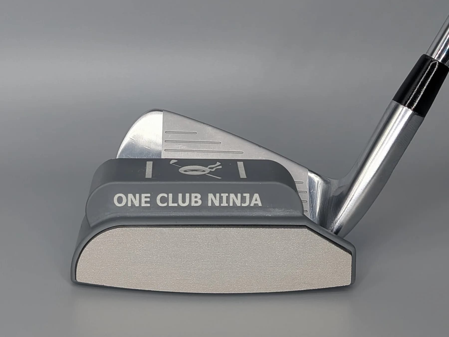 The One Club Ninja magnetic putter attachment clipped onto a 7-iron