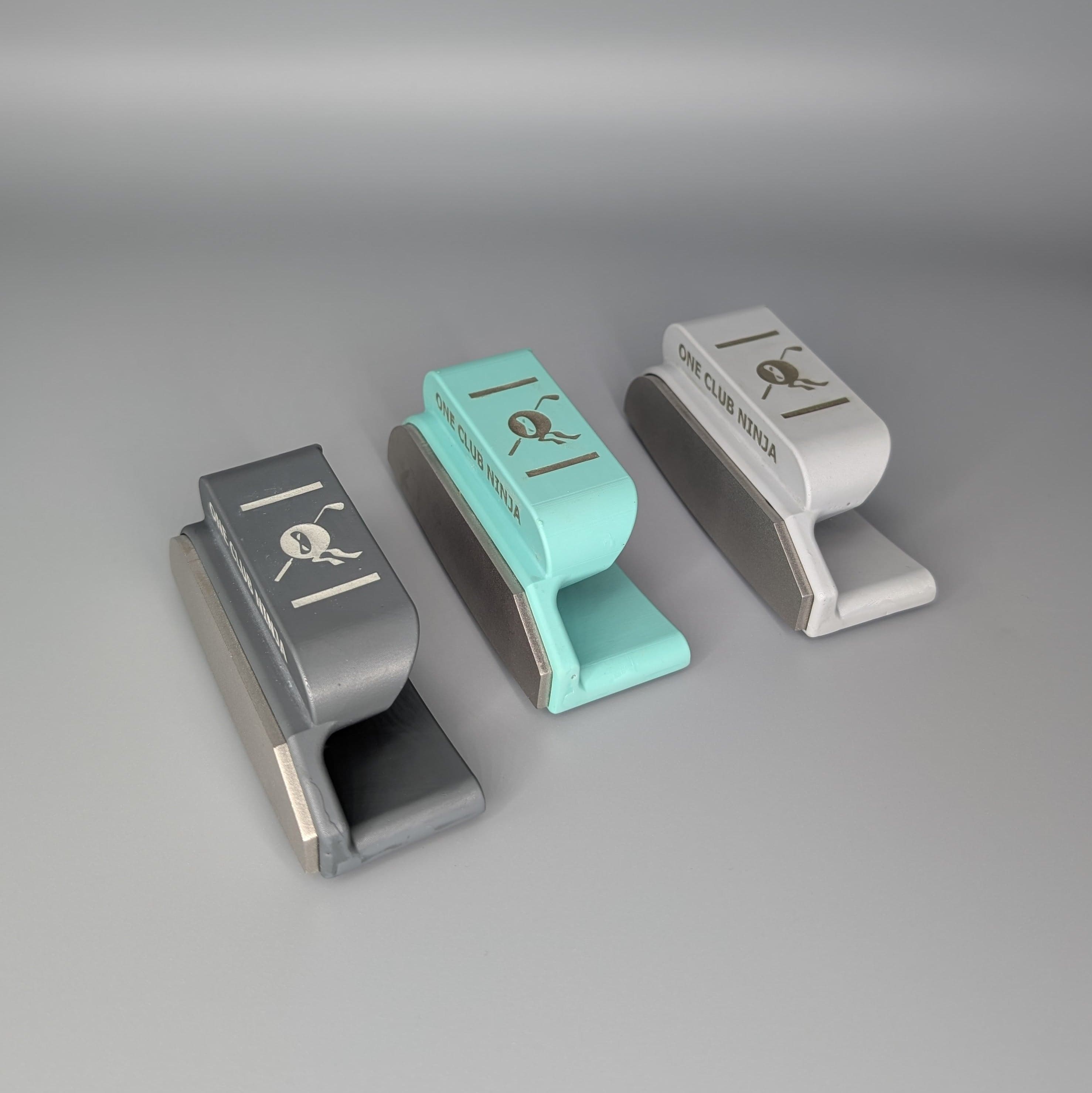 Three One Club Ninja putter attachments in three colors lined up